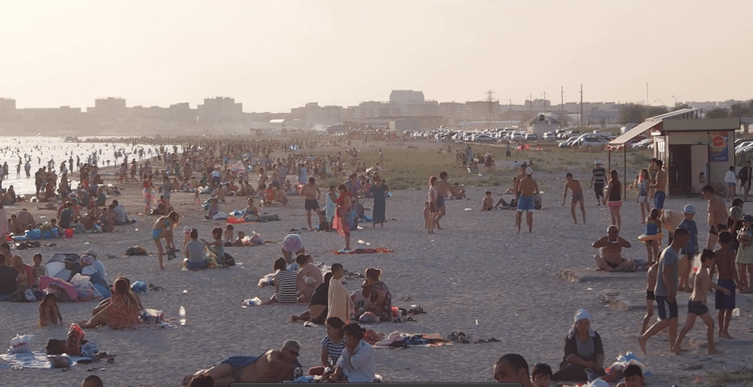 Beach Time Kazakhstan.locals Cooling Off In The Caspian Sea On A Hot Summers Day.