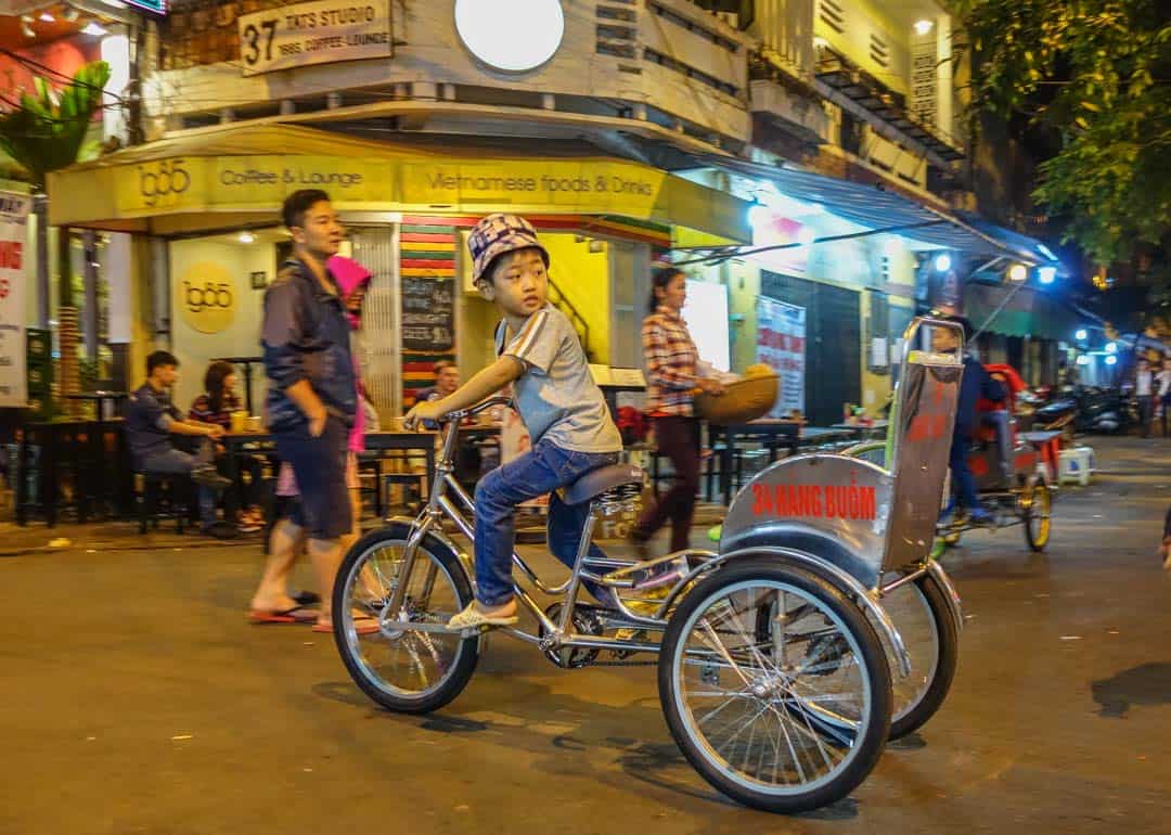 Boy Riding Through Markets