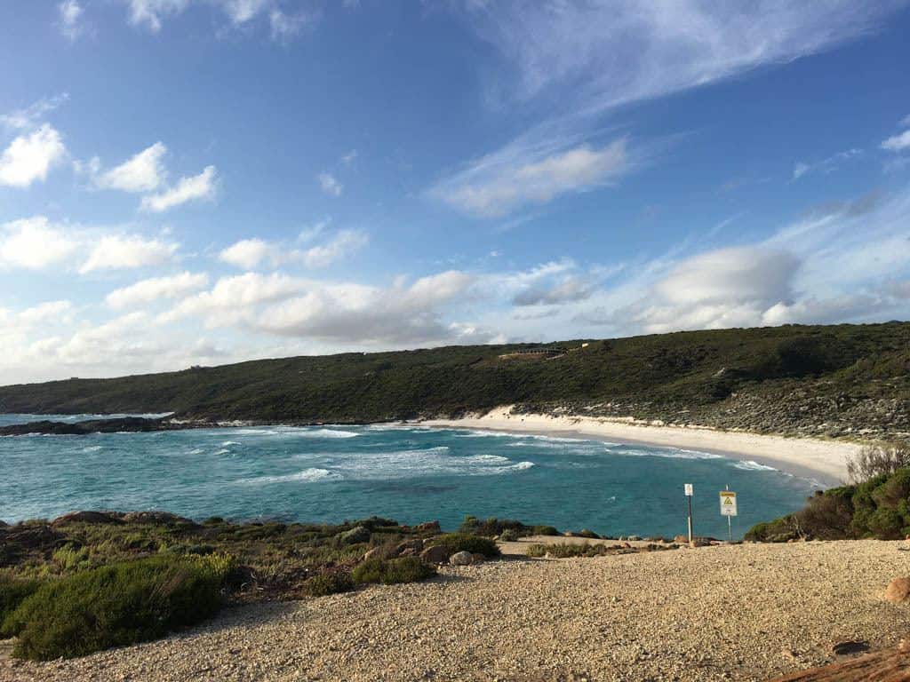 White Sand Beach On A Blue Sky Day With Clouds