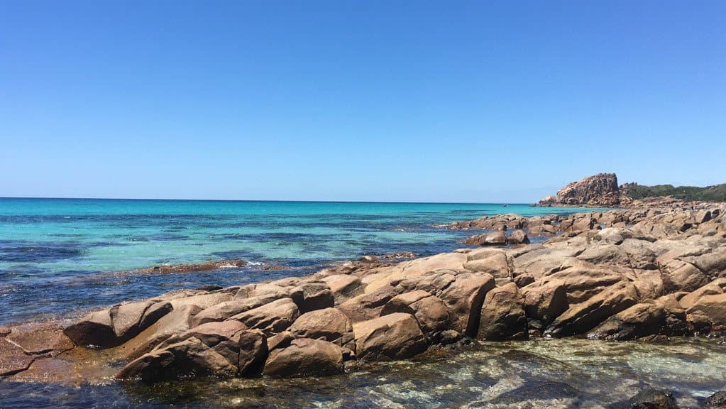 Clear Blue Waters On A Clear Day With Rocks 