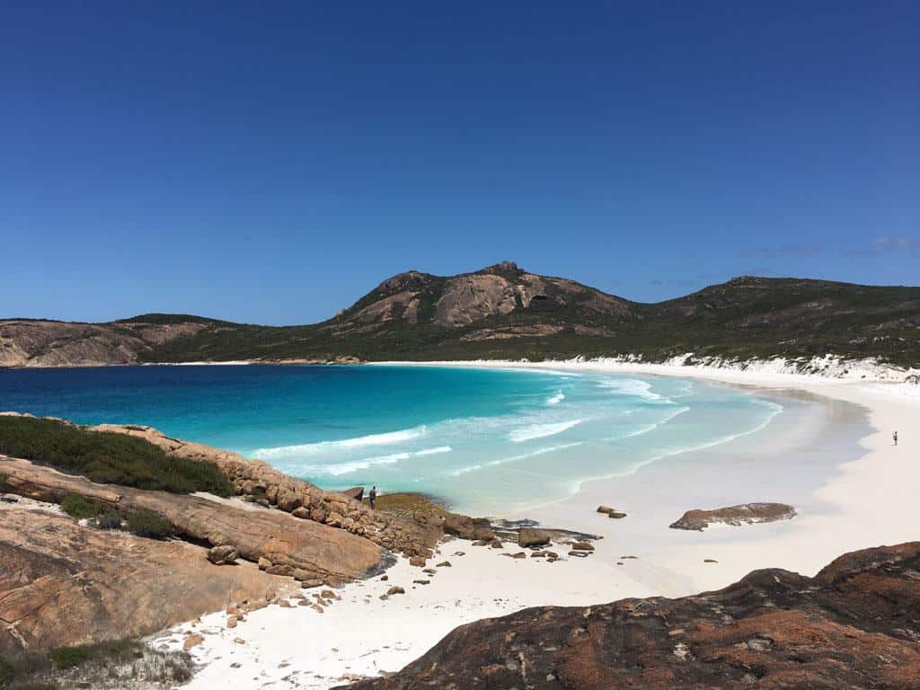 White Sand Beach With Hills In The Background