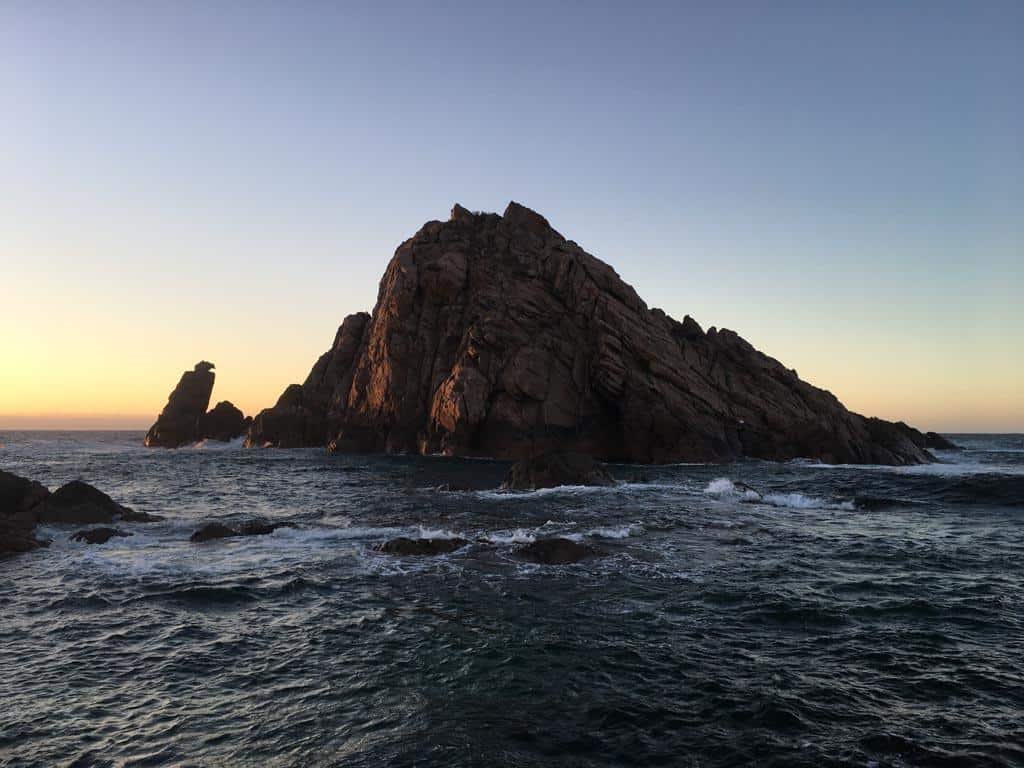 Huge Rock Out In The Ocean At Sunset 