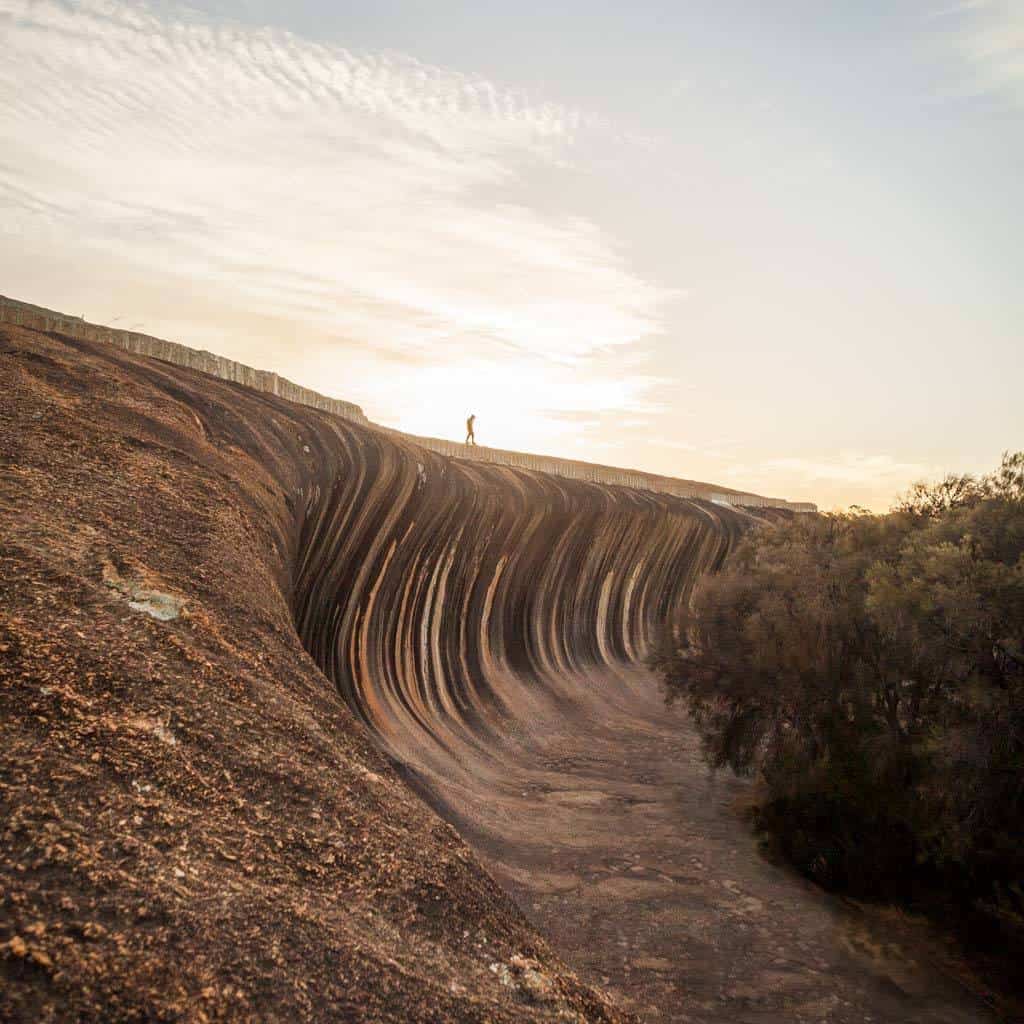 Wave Shaped Rock With Person Standing On Top