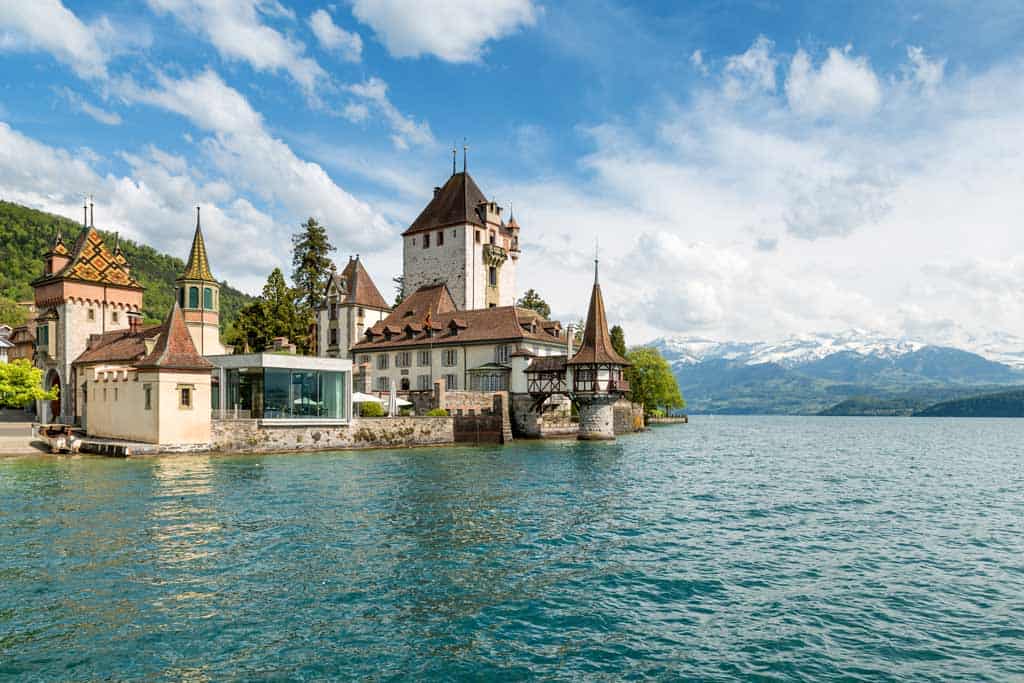 Beautiful Little Tower Of Oberhofen Castle In The Thun Lake With Mountains On Background In Switzerland, Near Bern.