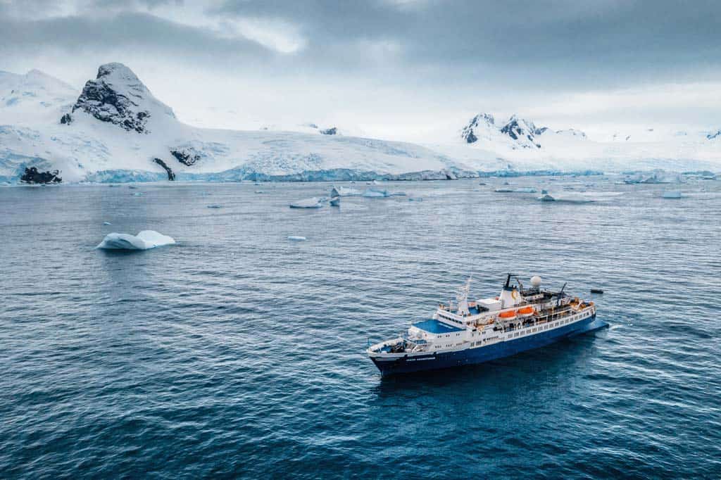 Boat In Water Surround By Ice Mountains