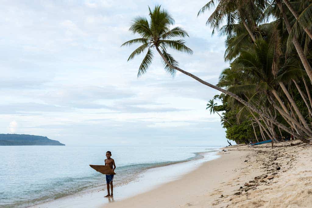 Young Boy Holding A Skimboard