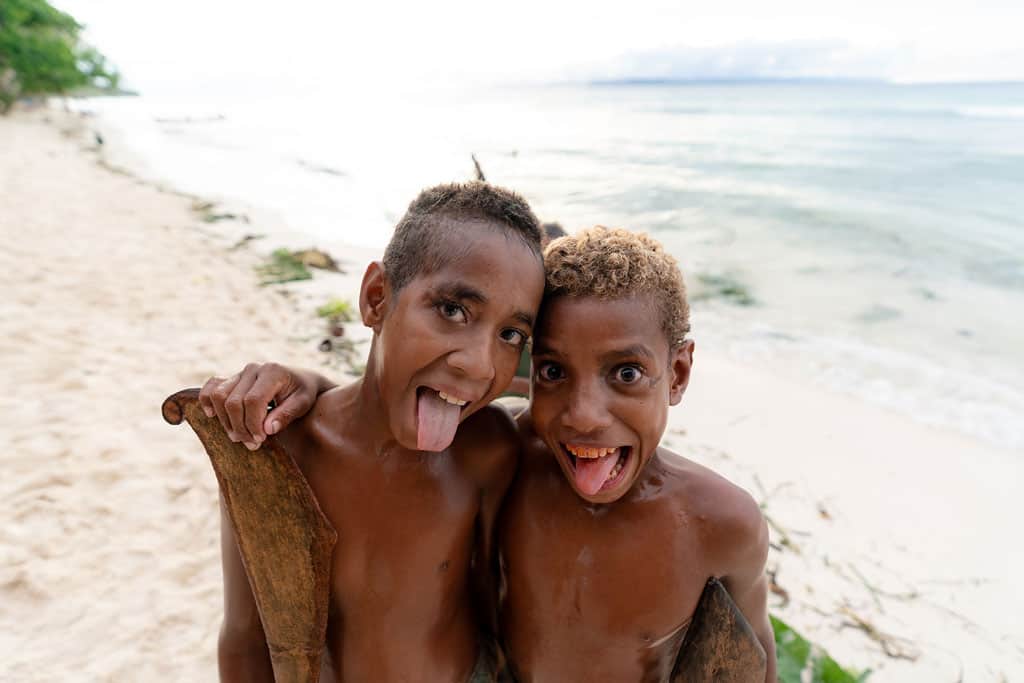 Two Boys Post For A Photo. The Kids Here Are As Playful As They Are Cheeky.