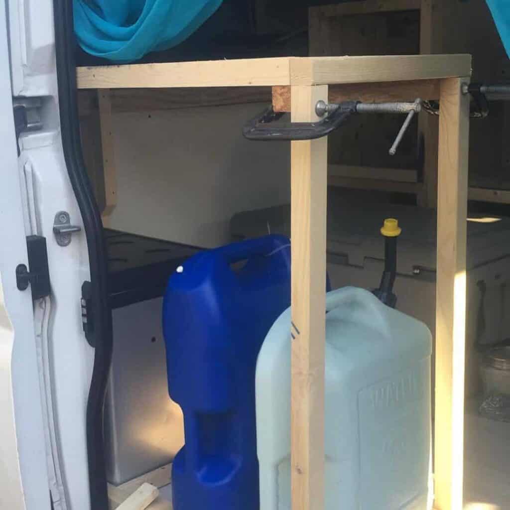 Two Portable Water Containers In A Van