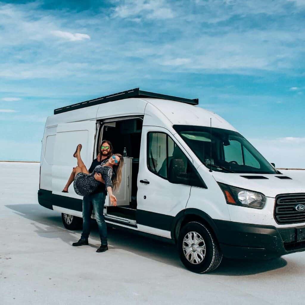 Couple Standing Outside Ford Transit Van Life