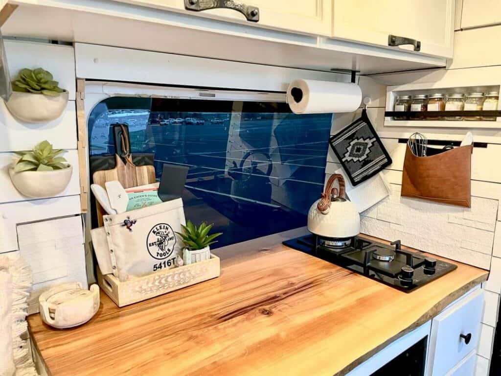 Live Edge Counters And A Two Burner Stove Top In A Campervan