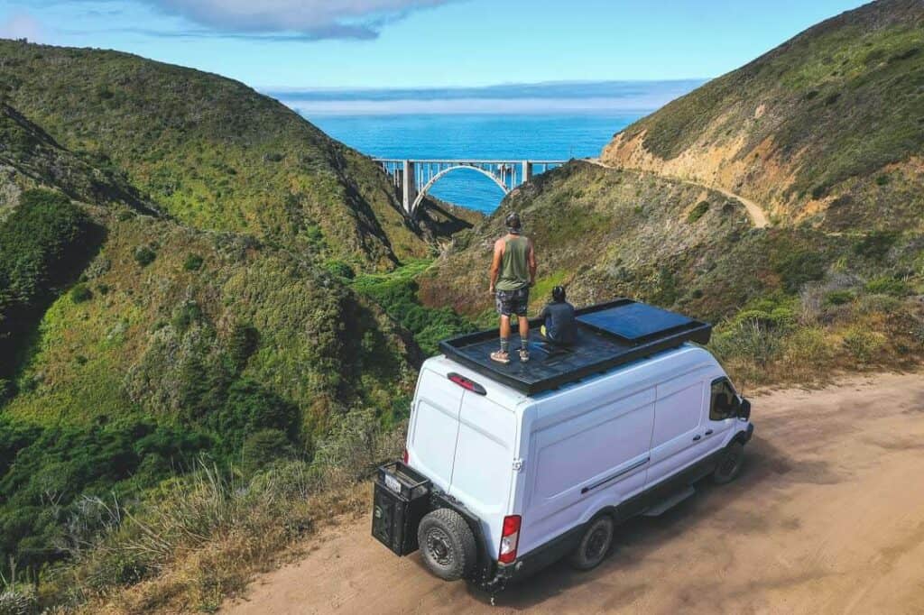 Ford Transit Van With Guys On Roof Deck With View Of The Ocean