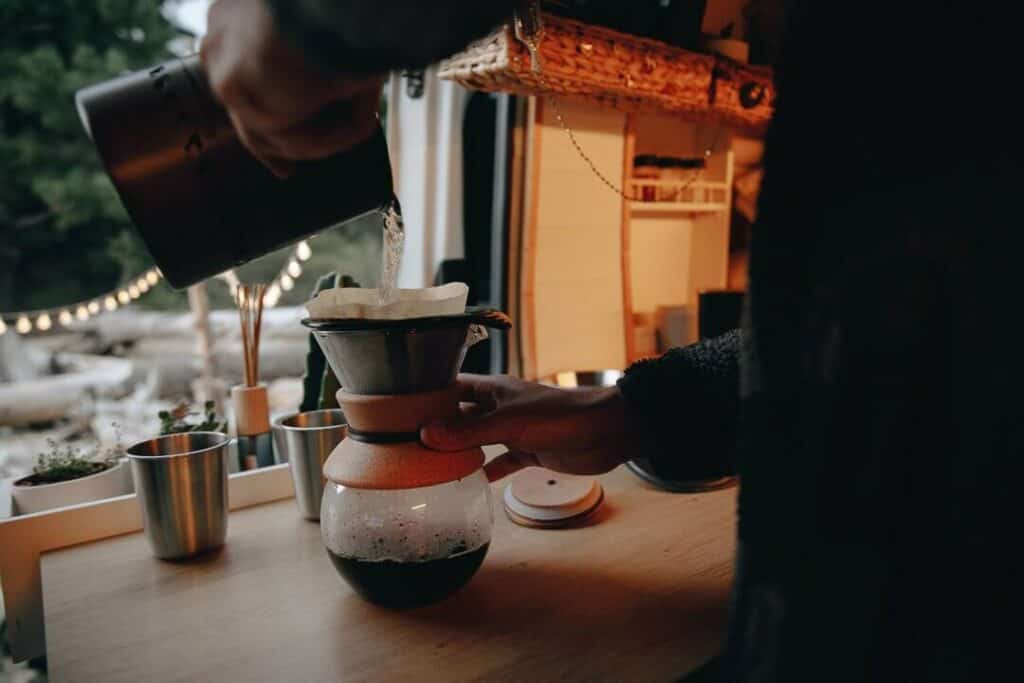 Person Making Pour Over Coffee In A Van