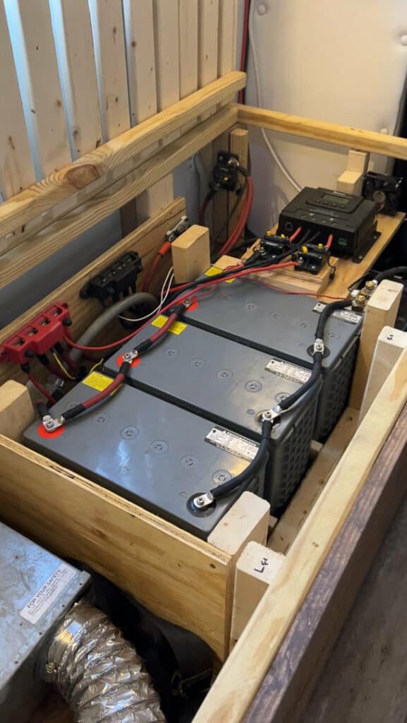 Battery Bank And Solar Charge Controller Set Up Under A Couch In A Van